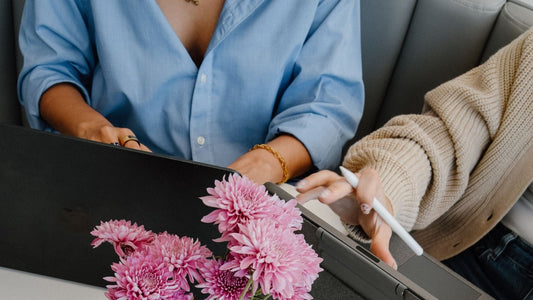 Two people reviewing a social media strategy on a laptop during a kickoff call